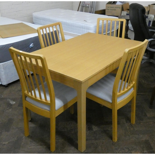 137 - A modern light oak extending dining table with additional leaf and four matching chairs with grey up... 