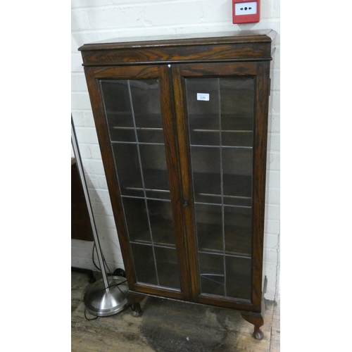 228 - A 1920's leaded glazed oak bookcase on small cabriole legs