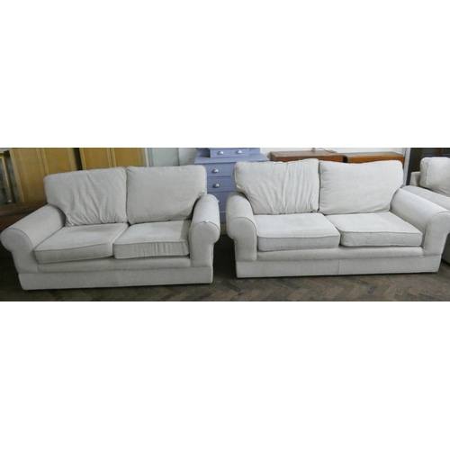 229 - A pair of modern cream chenille two seater sofas