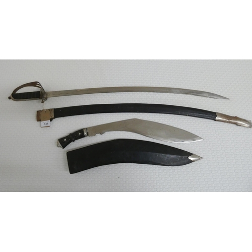 134 - A Kukri in scabbard and a curved sword in scabbard