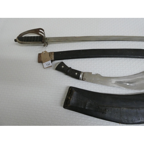 134 - A Kukri in scabbard and a curved sword in scabbard