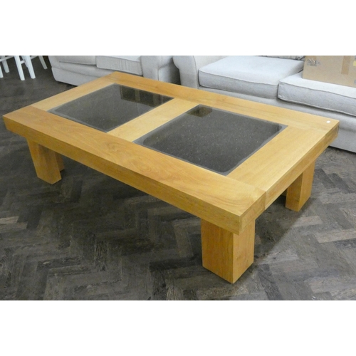 3 - A large modern chunky light oak coffee table with two square glass tops to the centre