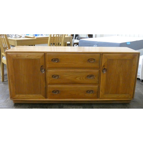 1 - A modern blonde elm Ercol sideboard fitted three centre drawers with cupboards to each end, 61