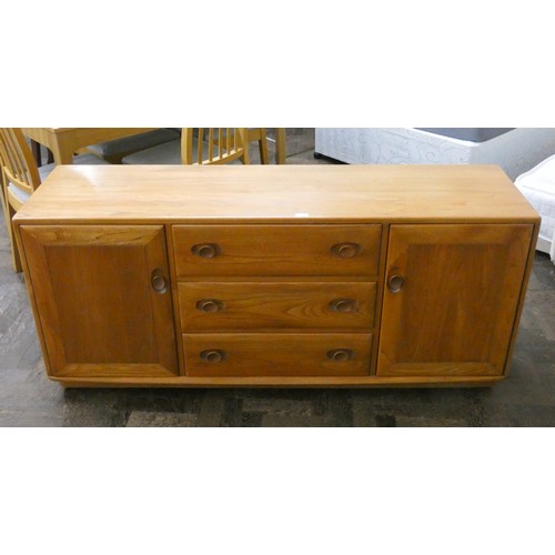 1 - A modern blonde elm Ercol sideboard fitted three centre drawers with cupboards to each end, 61