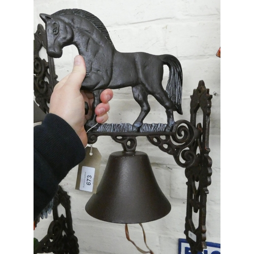 665 - A heavy horse style cast iron wall hanging door bell