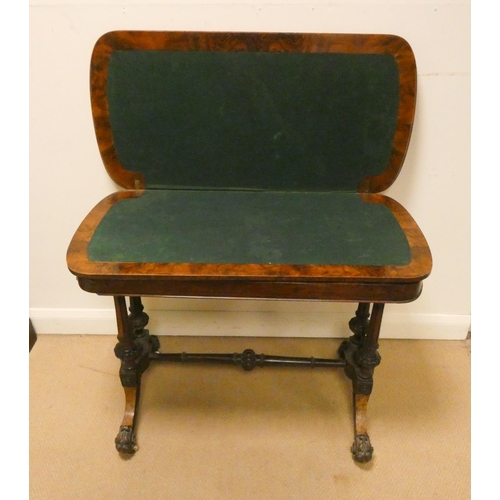 155 - A Victorian inlaid walnut folding top card table on a carved stretcher style base, 37