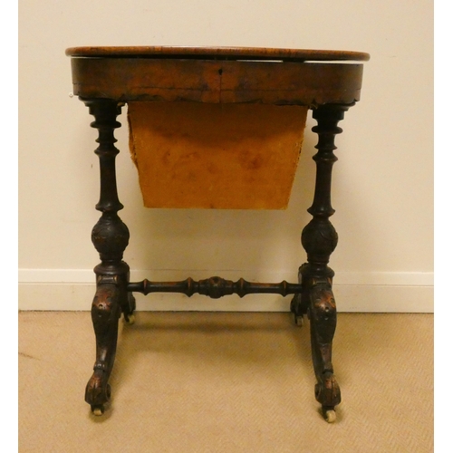 156 - Victorian walnut oval work box on carved stretcher base with fret work decorated interior, 24 1/2