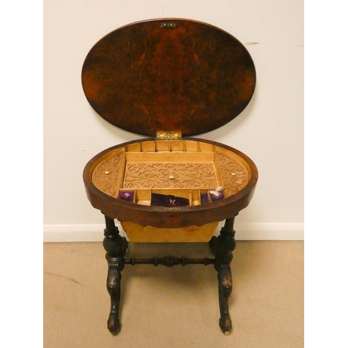 156 - Victorian walnut oval work box on carved stretcher base with fret work decorated interior, 24 1/2