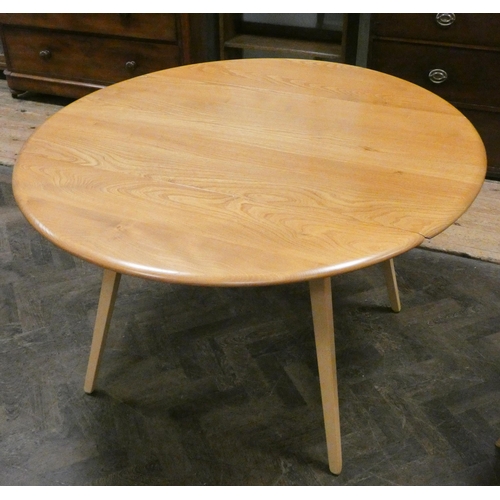 161 - An Ercol blonde elm drop leaf dining table and four matching high stick back dining room chairs