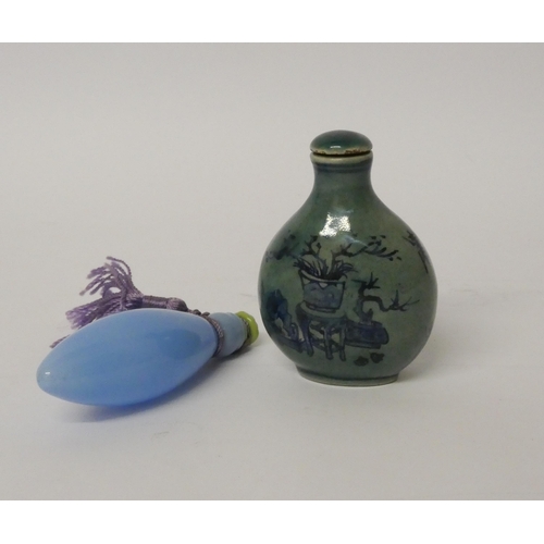 470 - An oriental porcelain snuff bottle and a blue glass scent flask