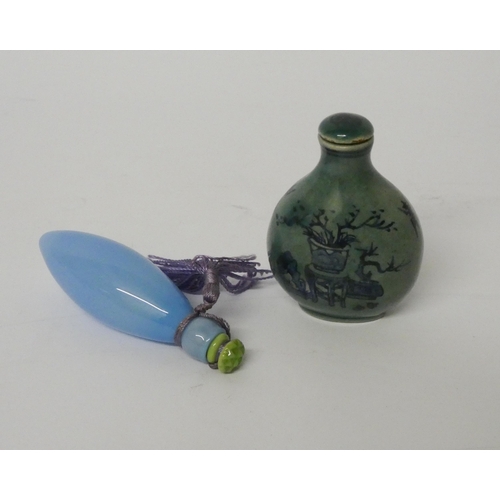 470 - An oriental porcelain snuff bottle and a blue glass scent flask