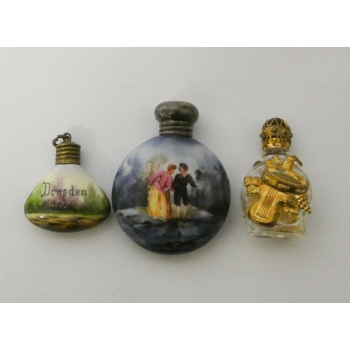 473 - A moon shaped scent flask with silver top Birmingham 1906, with two smaller scent bottles with gilt ... 