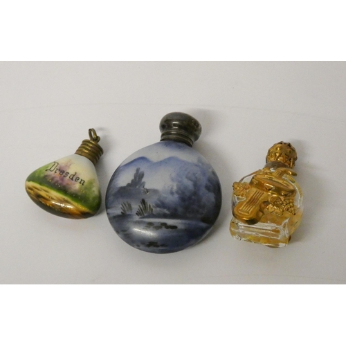 473 - A moon shaped scent flask with silver top Birmingham 1906, with two smaller scent bottles with gilt ... 