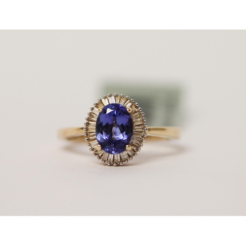 501 - A modern tanzanite and diamond oval cluster ring, the central tanzanite weighing 1.3 carats. Ring si... 