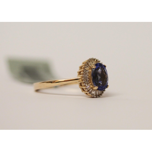 501 - A modern tanzanite and diamond oval cluster ring, the central tanzanite weighing 1.3 carats. Ring si... 