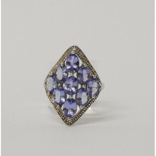 502 - A large modern tanzanite and diamond dress ring, on 9ct white gold band. With certificate. Weight 3.... 