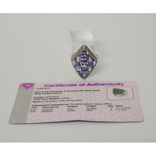 502 - A large modern tanzanite and diamond dress ring, on 9ct white gold band. With certificate. Weight 3.... 