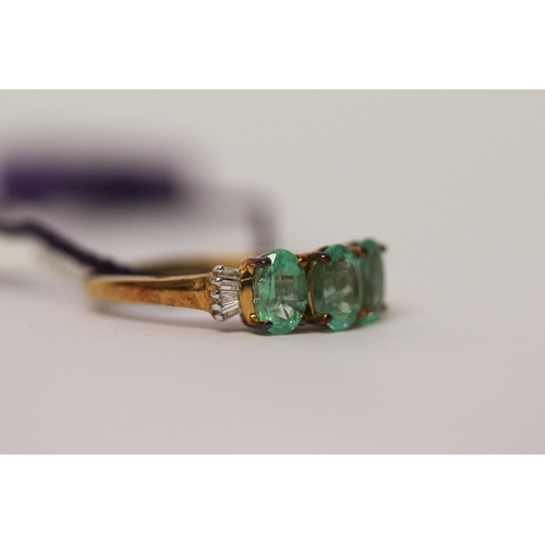 506 - A modern three stone emerald and diamond ring, as new with tags and box, ring size K