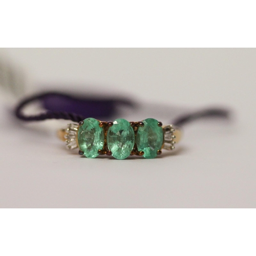 506 - A modern three stone emerald and diamond ring, as new with tags and box, ring size K