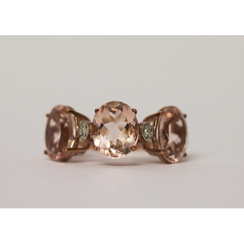 510 - A modern three stone Morganite and diamond dress ring, on 9ct rose gold band. ring size J, 2.8g