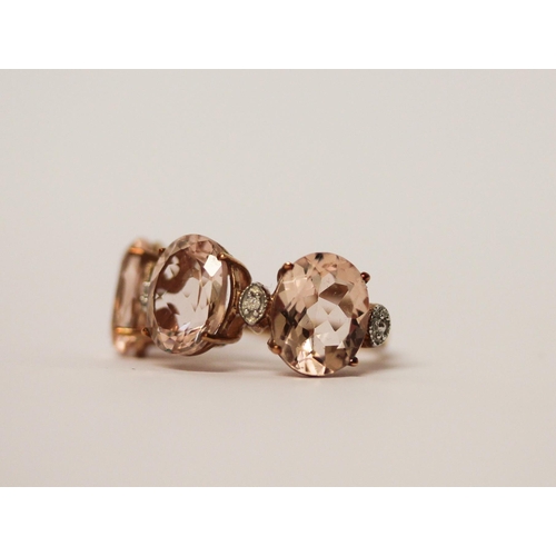 510 - A modern three stone Morganite and diamond dress ring, on 9ct rose gold band. ring size J, 2.8g