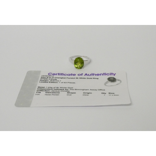 516 - A peridot single stone dress ring on 9ct white gold band. With certificate. Ring size N