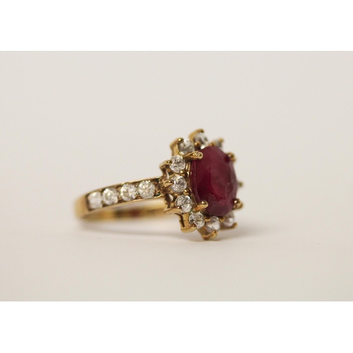 517 - A ruby and zircon dress ring on 9ct gold band. Ring size M