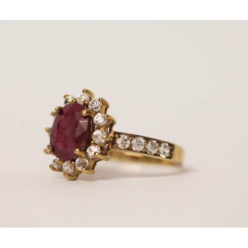 517 - A ruby and zircon dress ring on 9ct gold band. Ring size M