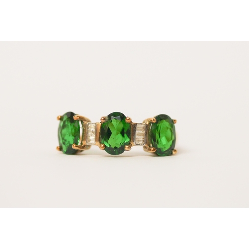 518 - A diamond and three stone green diopside ring on 9ct gold band. With certificate, ring size O