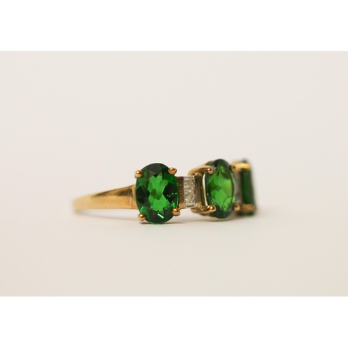 518 - A diamond and three stone green diopside ring on 9ct gold band. With certificate, ring size O