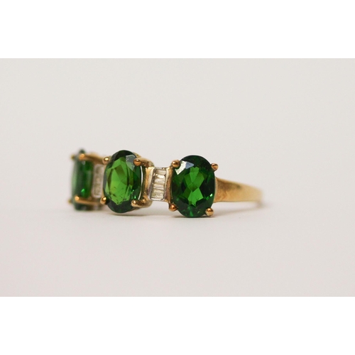 518 - A diamond and three stone green diopside ring on 9ct gold band. With certificate, ring size O