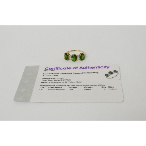 518 - A diamond and three stone green diopside ring on 9ct gold band. With certificate, ring size O