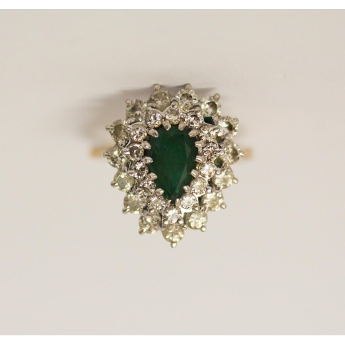 407 - An emerald and diamond cluster ring, the tear drop shaped emerald surrounded by two rows of diamonds... 