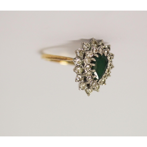 407 - An emerald and diamond cluster ring, the tear drop shaped emerald surrounded by two rows of diamonds... 