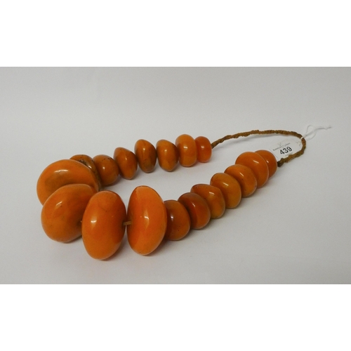 439 - Large amber look bead necklace, largest bead diameter 6.5 cms