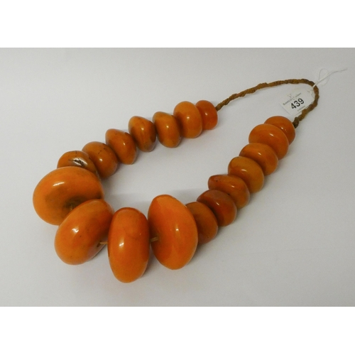 439 - Large amber look bead necklace, largest bead diameter 6.5 cms