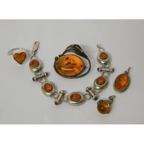 442 - Amber and silver jewellery - a bracelet, brooch, two pendants and a ring.