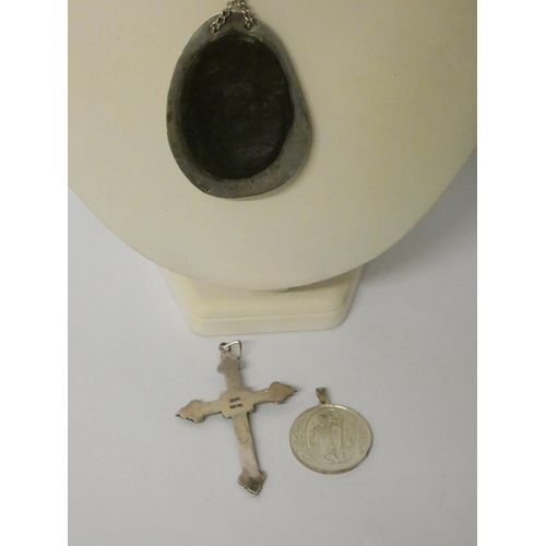 443 - A large silver framed pendant with arts and crafts panel, large opal cross pendant and a St Christop... 