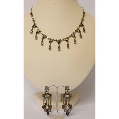 444 - A silver fringe necklace set with various coloured semi-precious gemstones and a pair of matching pi... 