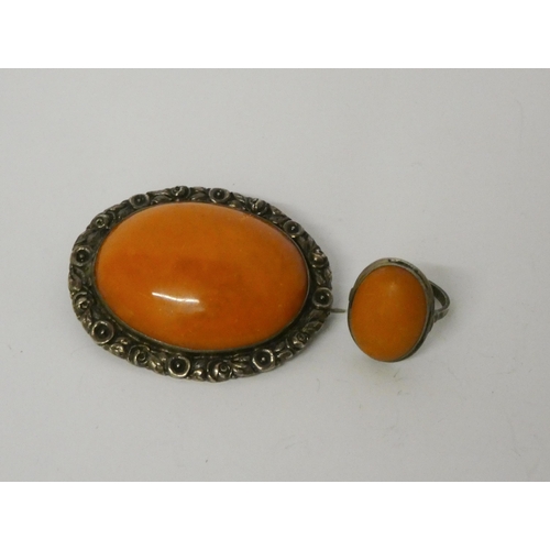 453 - A butterscotch amber oval brooch in 935 standard continental silver frame and a Scandinavian amber p... 