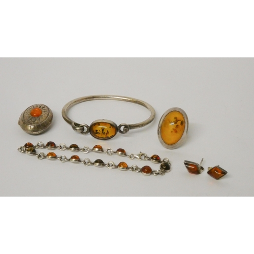 454 - Amber and silver jewellery - a bangle, locket, dress ring, ear studs and a bracelet.