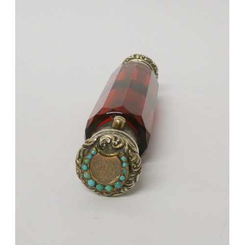 476 - A Victorian ruby glass double ended scent bottle with gilded white metal caps, one inset with turquo... 