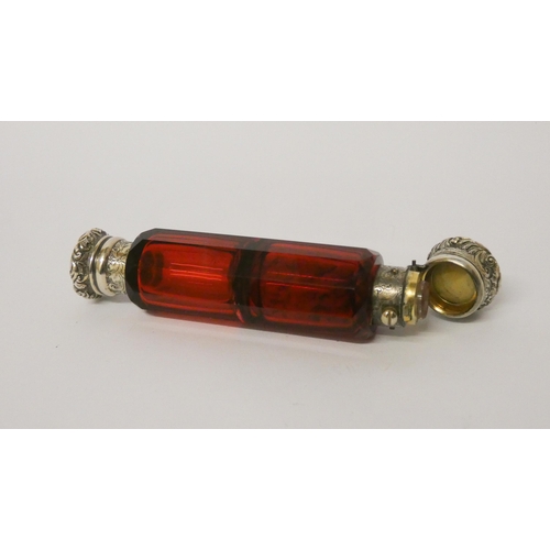 476 - A Victorian ruby glass double ended scent bottle with gilded white metal caps, one inset with turquo... 