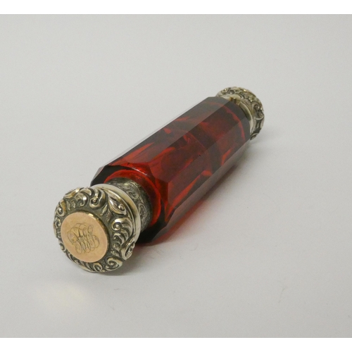 476 - A Victorian ruby glass double ended scent bottle with gilded white metal caps, one inset with turquo... 