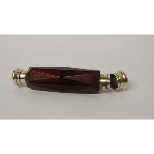 478 - A Victorian double ended faceted ruby glass scent bottle, with screw and hinged lids. 13.5 cms long