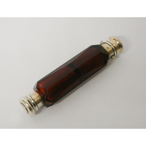 478 - A Victorian double ended faceted ruby glass scent bottle, with screw and hinged lids. 13.5 cms long