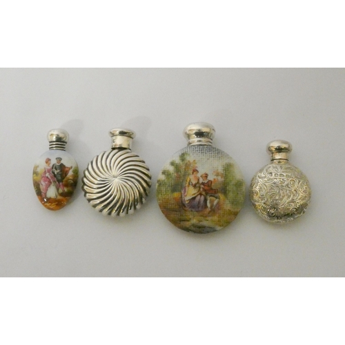 482 - A collection of four scent flasks, two moon shaped hallmarked silver examples and two porcelain and ... 