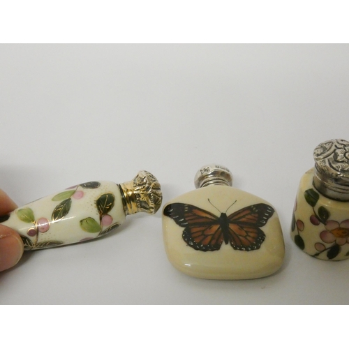 486 - A collection of three silver topped porcelain scent bottles, all with painted decoration. Longest me... 