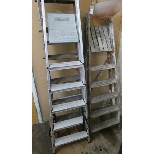 662 - Two sets of wooden step ladders and one set of aluminium step ladders