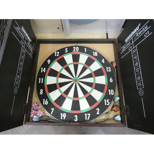 701 - A Winmau dart board in wall hanging case with two sets of darts